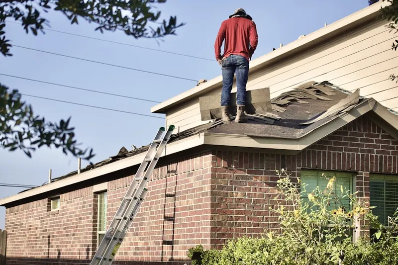 Professional roofer working on a residential roof in Hampton